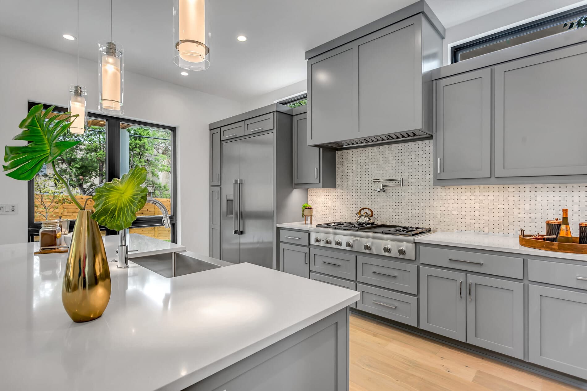 Modern kitchen with gray cabinetry and white countertops
